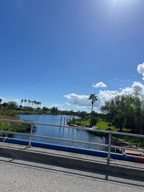 A view of a canal from a bridge with palm trees and a blue sky — 13100 ELEANOR AVENUE, PORT CHARLOTTE, FL