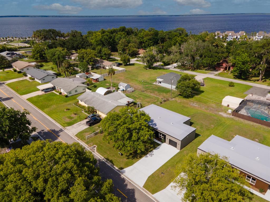 An aerial view shows a residential neighborhood with houses, green lawns, and a large lake — 455 RIVERVIEW AVENUE, SANFORD, FL