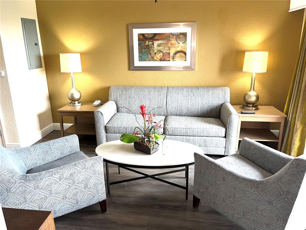 A living room features a gray sofa, two patterned armchairs, a coffee table, and lamps — 12544 FLORIDAYS RESORT DRIVE UNIT 612B, ORLANDO, FL