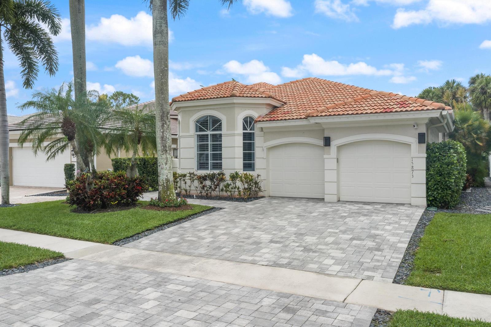 A single-story house with a tiled roof, two garage doors, and a paved driveway — 15873 Double Eagle Trail, Delray Beach FL 33446, DELRAY BEACH, FL