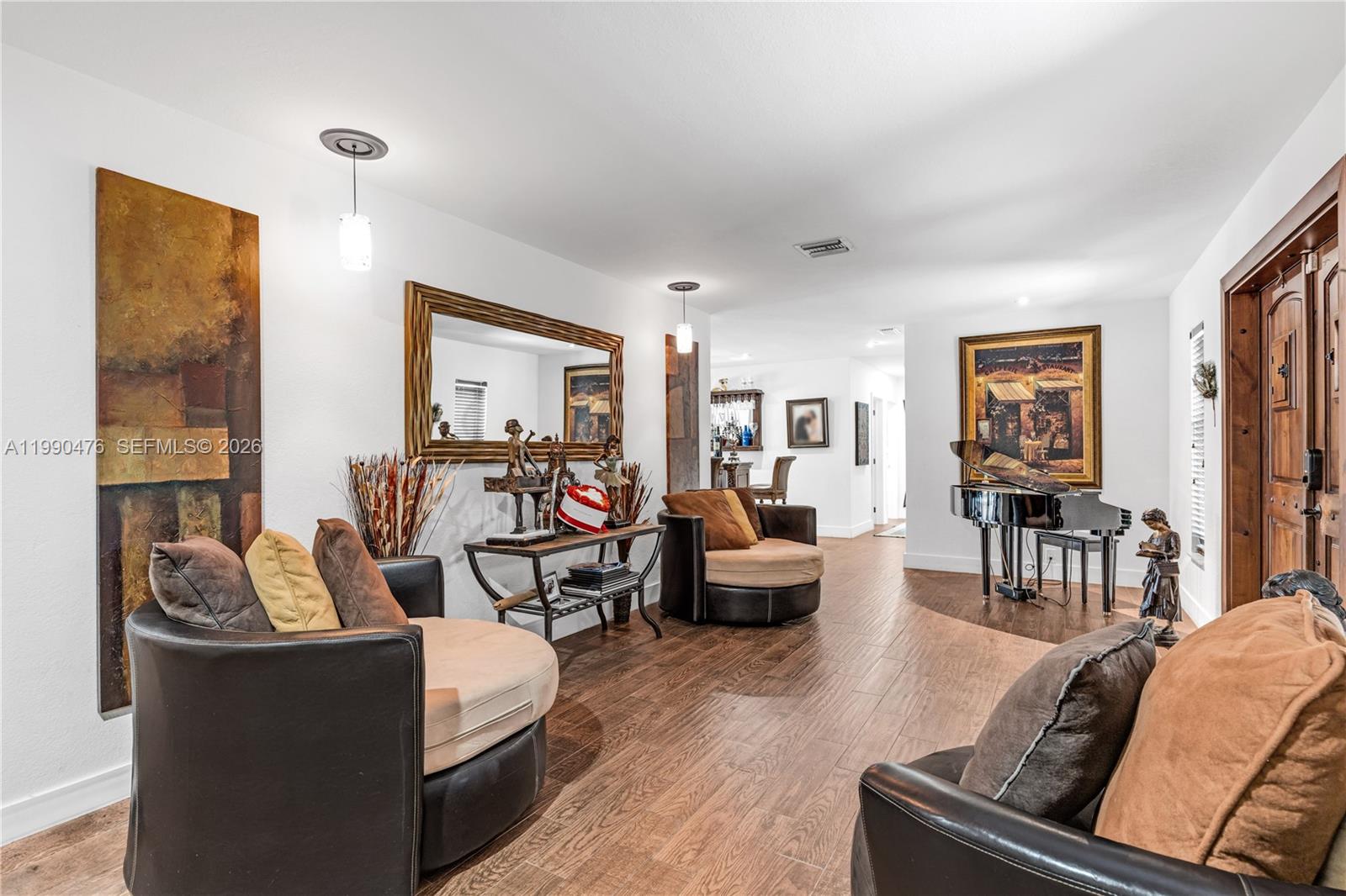 A living room features two round chairs, a console table, and a grand piano — 18851 SW 218th St, Miami FL 33170, MIAMI, FL
