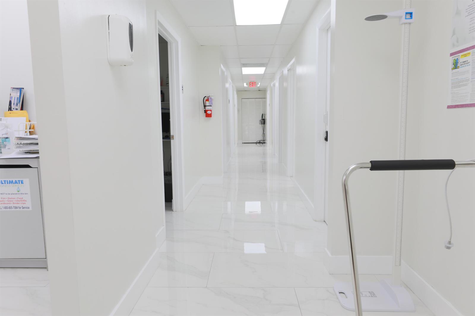 A bright, white medical office hallway features polished tile floors and several closed doors — 15490 NW 7th Avenue # B, Miami FL 33169, MIAMI, FL