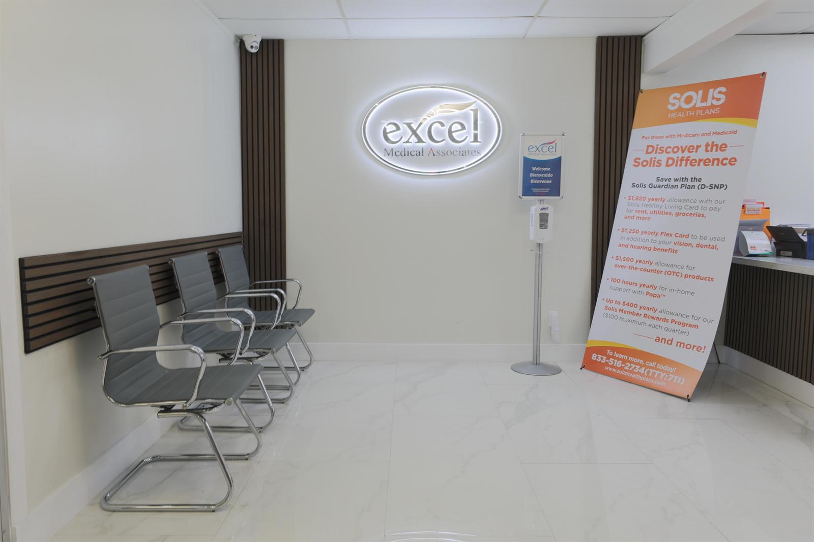 A waiting room features three gray chairs, a white tiled floor, and a branded sign — 15490 NW 7th Avenue # B, Miami FL 33169, MIAMI, FL