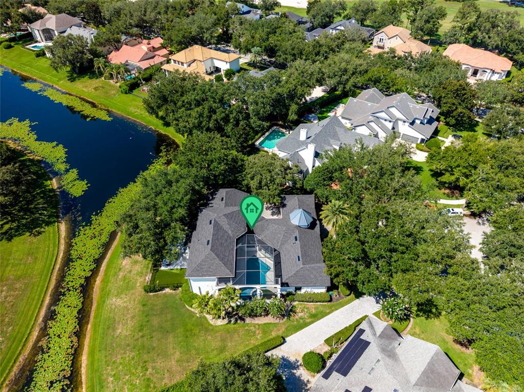 An aerial view shows a house with a screened pool and a green location marker — 9904 BRENTFORD COURT, WINDERMERE, FL