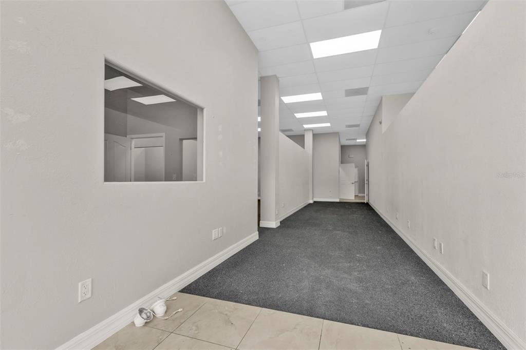 An empty commercial office space with gray carpet, white walls, and a drop ceiling — 4694 TAMIAMI TRAIL, PUNTA GORDA, FL
