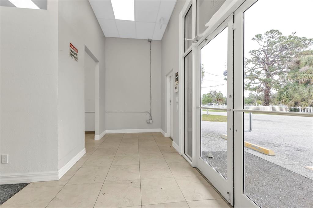 A commercial entryway features beige tile flooring, gray walls, and a glass-paned double door — 4694 TAMIAMI TRAIL, PUNTA GORDA, FL