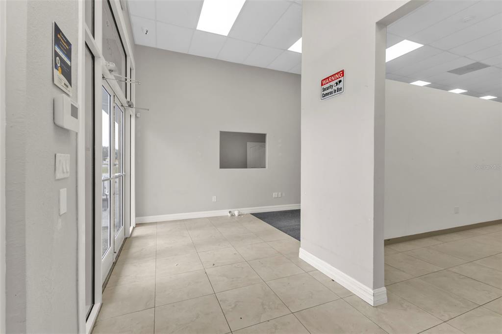 An interior view of a commercial space with light-colored tile flooring and white walls — 4694 TAMIAMI TRAIL, PUNTA GORDA, FL