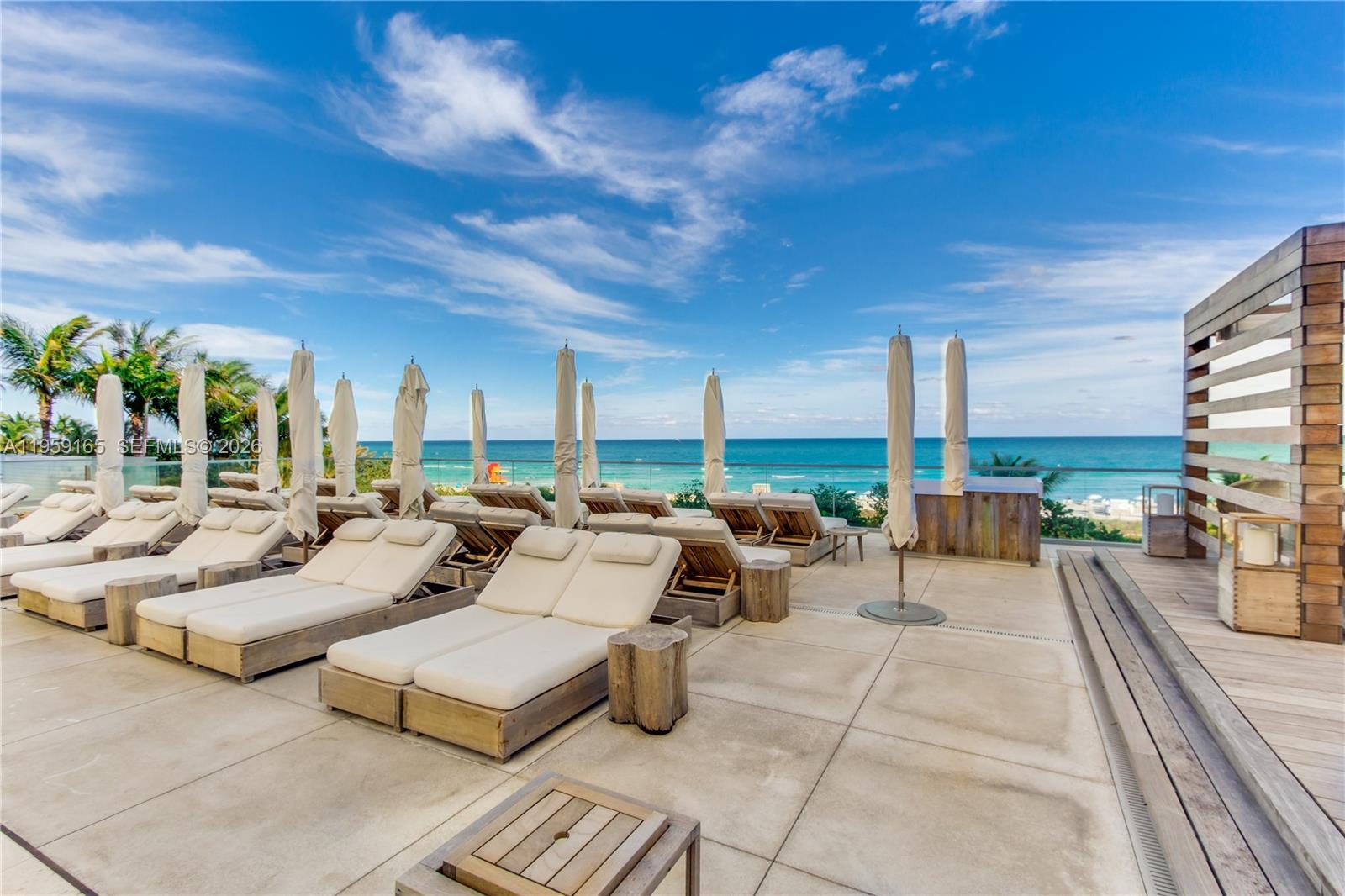 A living room features a white sofa, a wooden coffee table, and built-in shelving — 102 24th St # 1007, Miami Beach FL 33139, MIAMI BEACH, FL