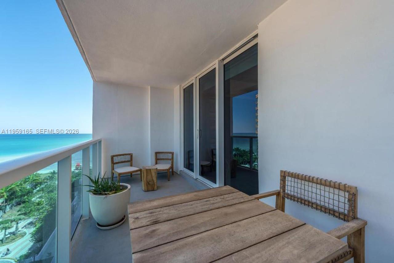 A bedroom features a king bed with a tufted headboard, bedside tables, and a desk — 102 24th St # 1007, Miami Beach FL 33139, MIAMI BEACH, FL