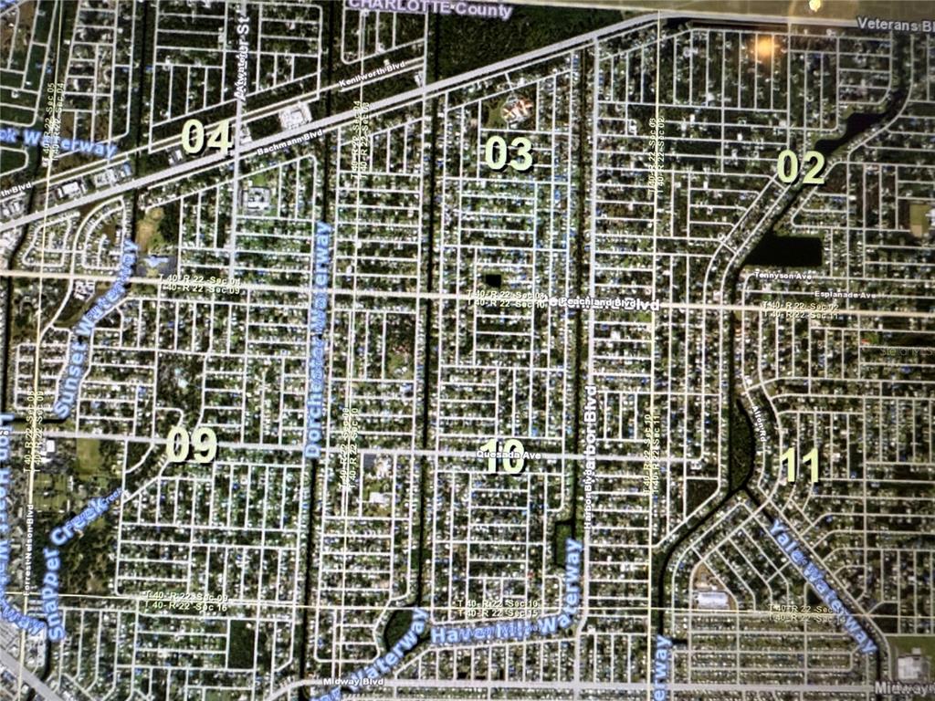 An aerial map view showing residential street grids, numbered sections, and various waterways — 1402 YORKSHIRE STREET, PORT CHARLOTTE, FL
