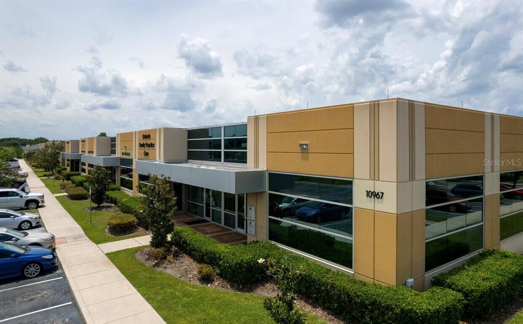 A low-rise commercial medical office building with a parking lot in the foreground — 10967 LAKE UNDERHILL ROAD UNIT 106, ORLANDO, FL
