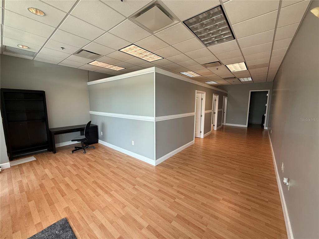 The exterior entrance of a commercial office suite features glass doors and windows with blinds — 10967 LAKE UNDERHILL ROAD UNIT 106, ORLANDO, FL