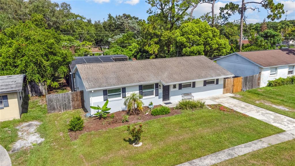 An aerial view of a single-story house with a gray roof and white exterior walls — 7924 PLUNKETT AVENUE, ORLANDO, FL