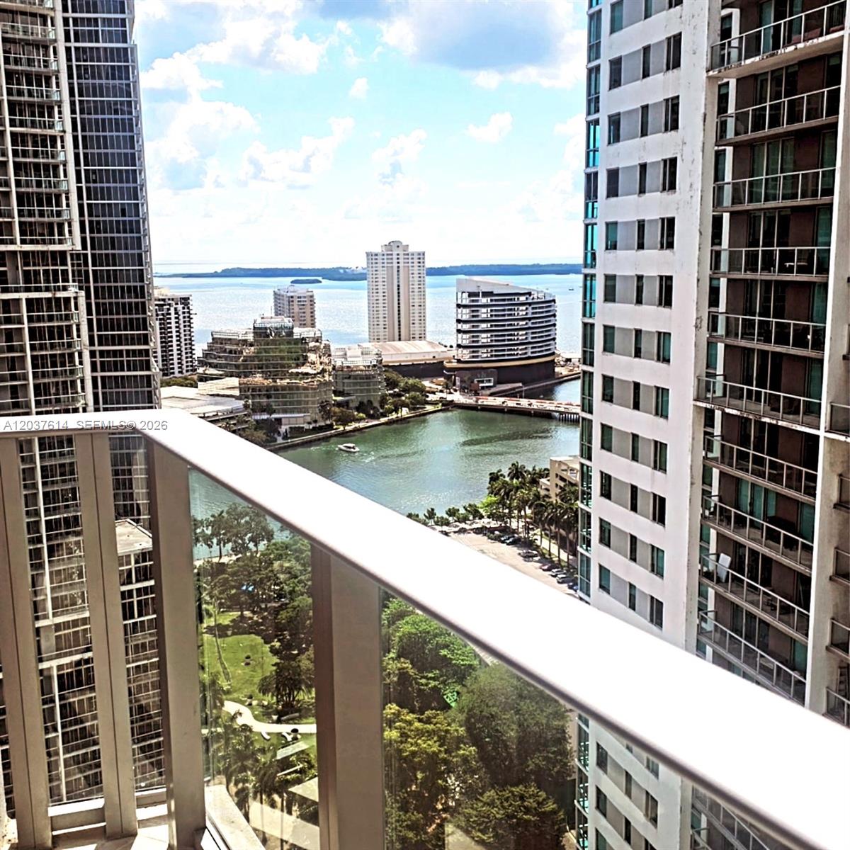 A high-rise balcony view overlooks a bay, a park, and surrounding urban buildings — 77 SE 5th Street # 2914, Miami FL 33131, MIAMI, FL