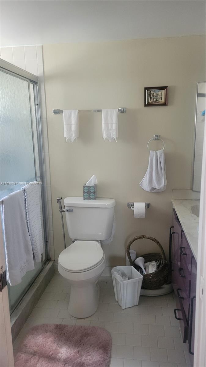 A bathroom features a toilet, a shower stall, a vanity, and wall-mounted towel racks — 6666 Spring Bottom Way # 179, Boca Raton FL 33433, BOCA RATON, FL