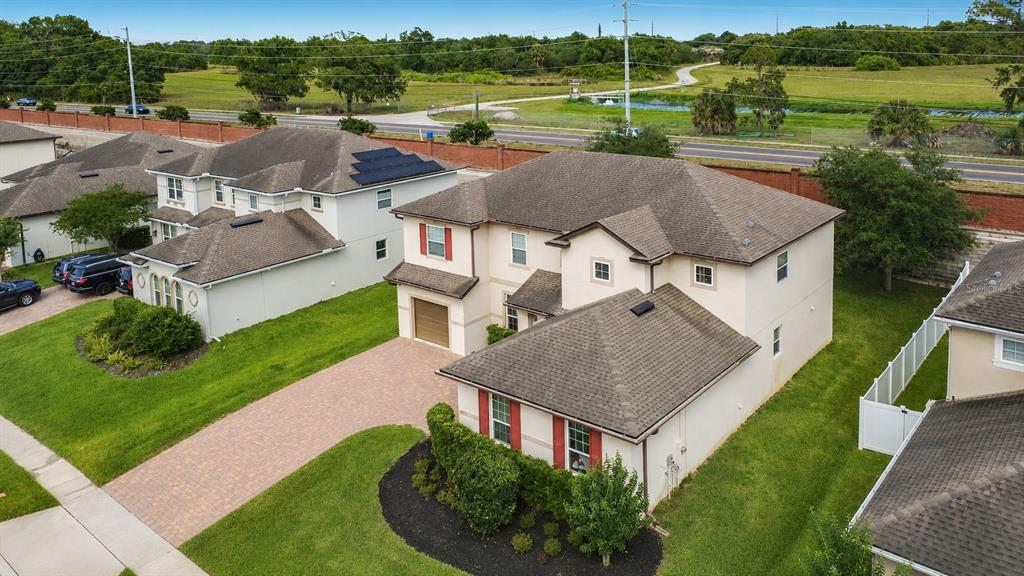 An aerial view shows a two-story suburban house with a paved driveway and shingled roof — 2771 WESTYN COVE LANE, OCOEE, FL