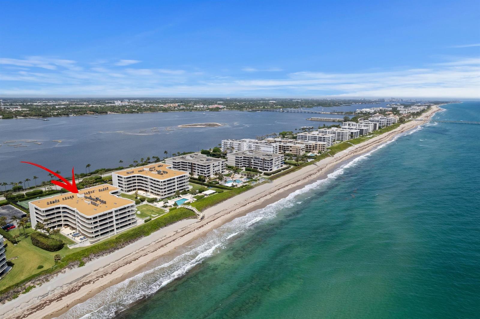 An aerial view of a beachfront condominium complex with a red arrow pointing down — 3300 S Ocean Boulevard # 504s, Palm Beach FL 33480, PALM BEACH, FL