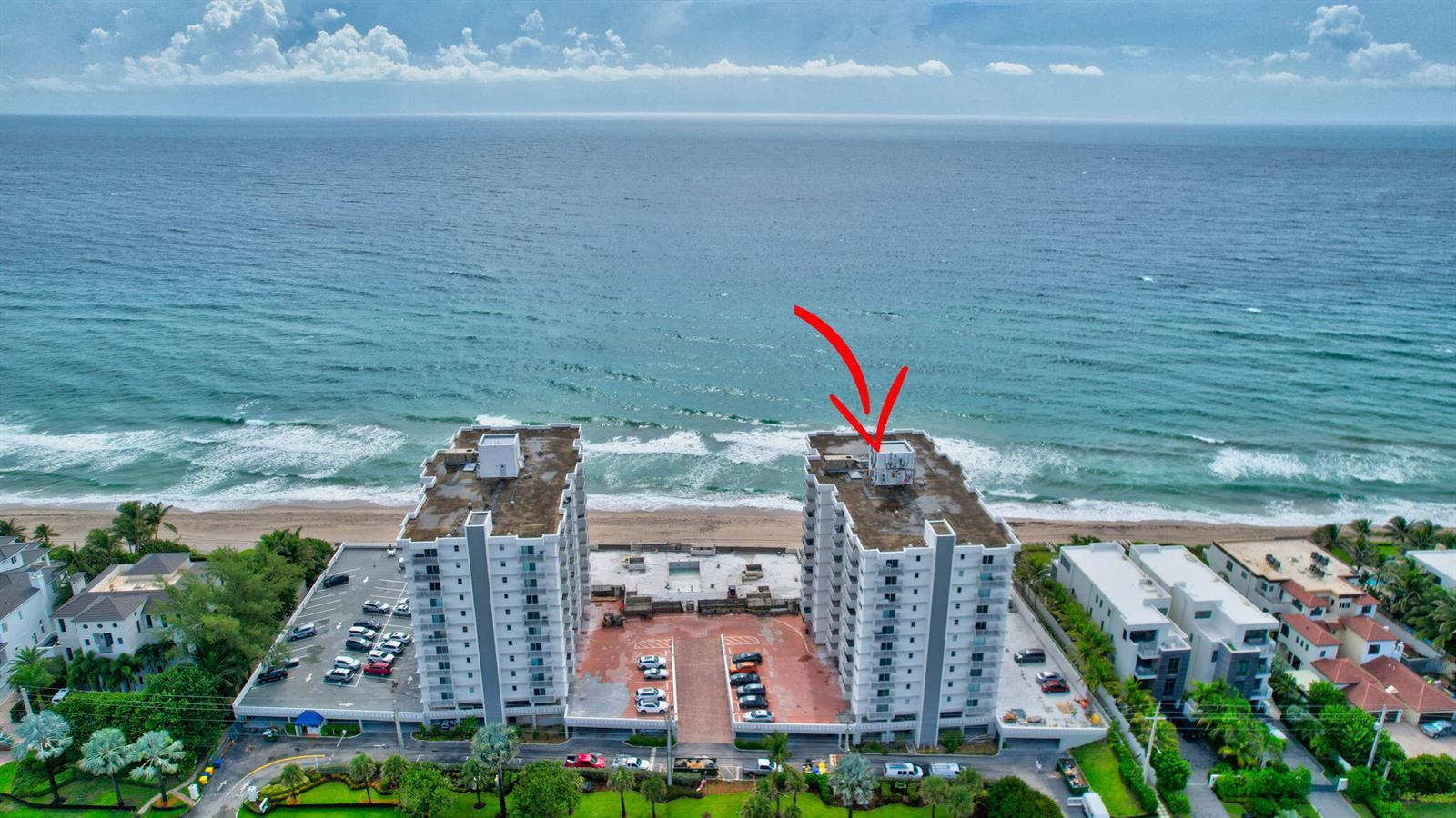 An aerial view of two beachfront apartment buildings with a red arrow pointing toward one — 4511 S Ocean Boulevard # 401, Highland Beach FL 33487, HIGHLAND BEACH, FL