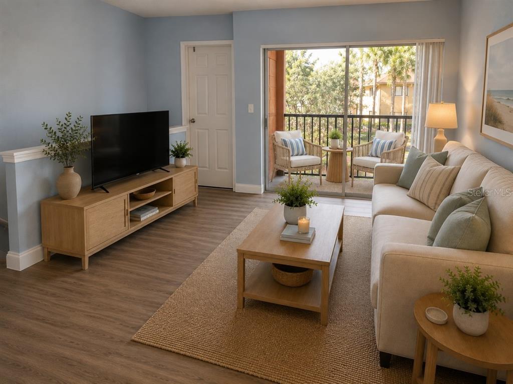A living room with light blue walls, wood-look flooring, a beige sofa, and a balcony — 5553 BAYWATER DRIVE, TAMPA, FL
