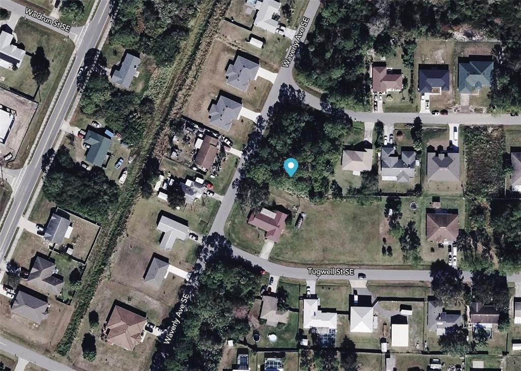 This is an aerial map view of a residential neighborhood with houses and wooded lots — 2051 WAVERLY AVENUE SE, PALM BAY, FL