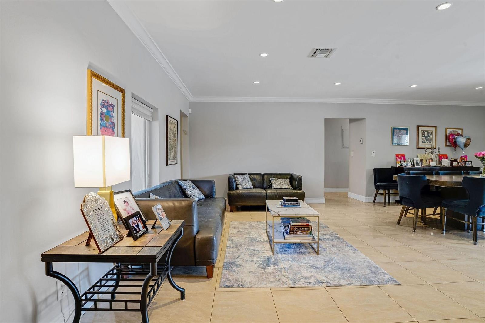 A living room features two dark leather sofas, a marble coffee table, and tile flooring — 4000 N 36th Avenue, Hollywood FL 33021, HOLLYWOOD, FL