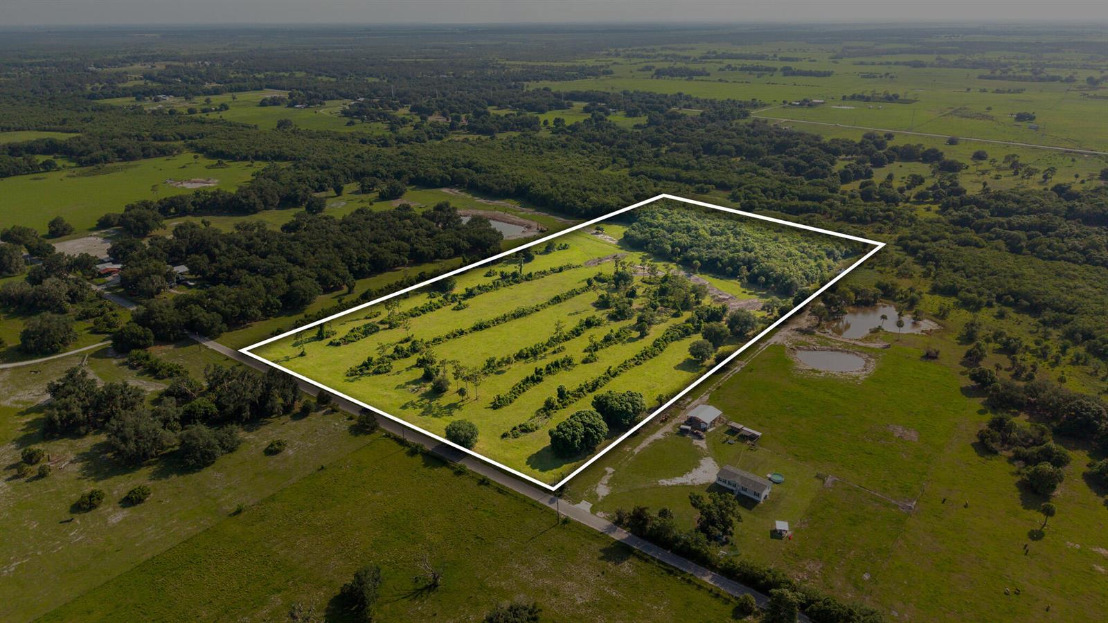 An aerial view shows a rectangular plot of land outlined in white amidst rural fields — 0 NW 190th Road, Okeechobee FL 34972, OKEECHOBEE, FL