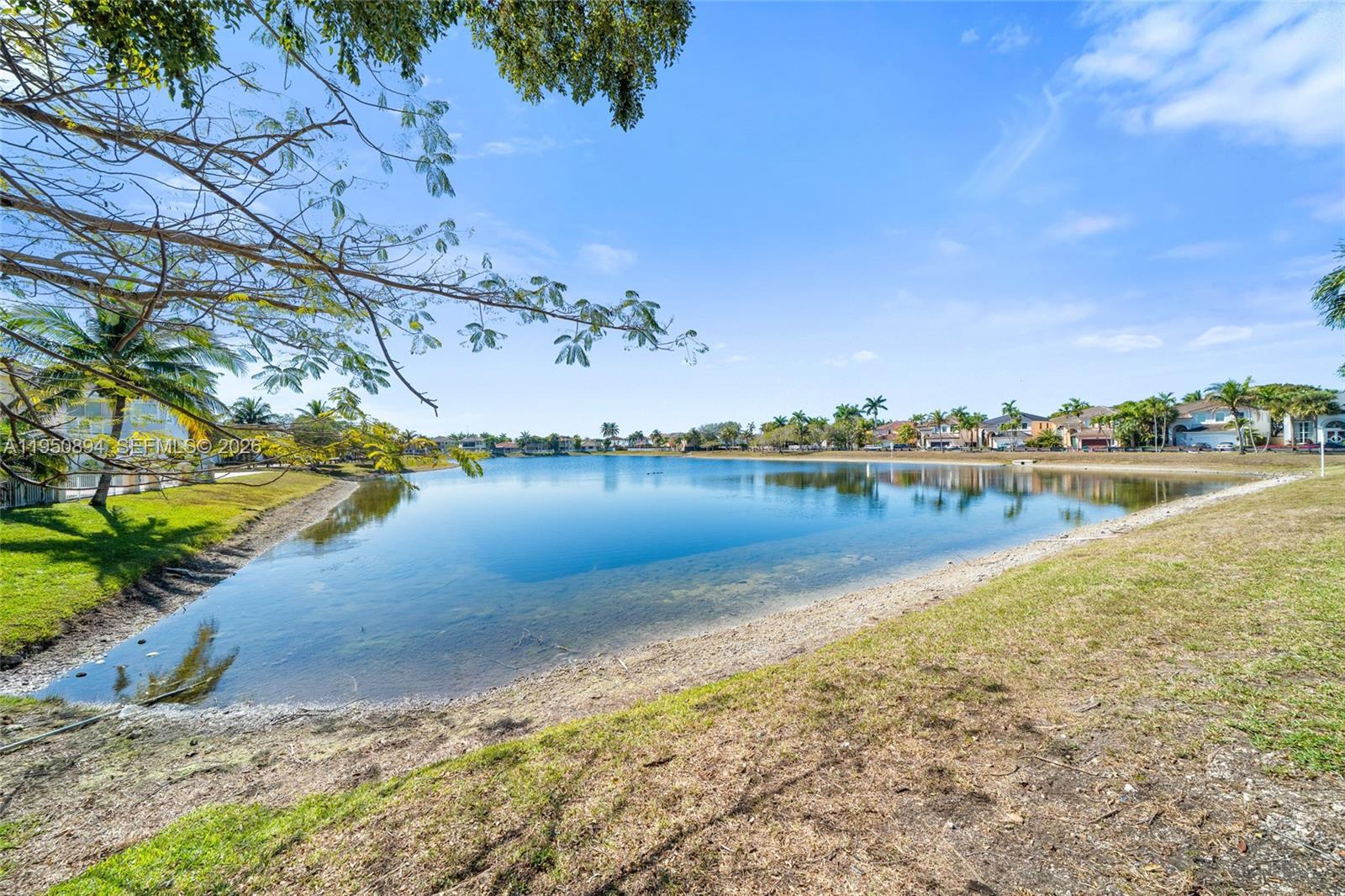 A two-story orange house features a paved driveway, a two-car garage, and a front entryway — 16062 SW 43rd Ter, Miami FL 33185, MIAMI, FL