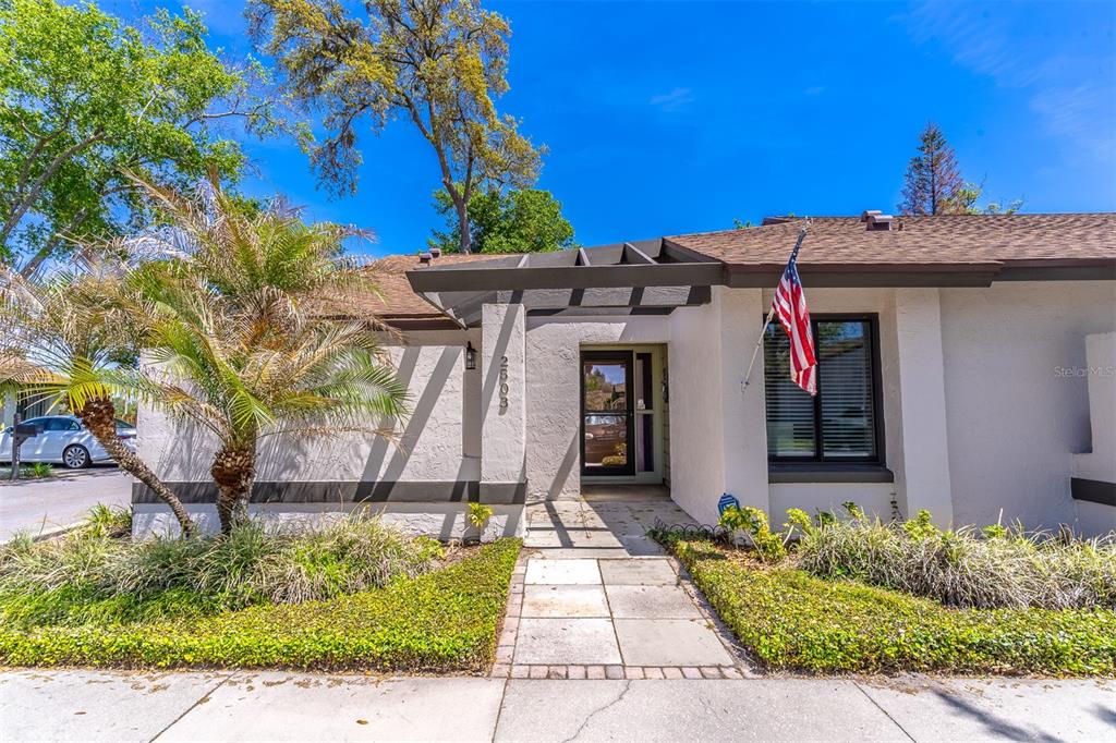 The exterior of a single-story home features a paved walkway leading to the front entrance — 2503 TAHOE CIRCLE UNIT 2503, WINTER PARK, FL