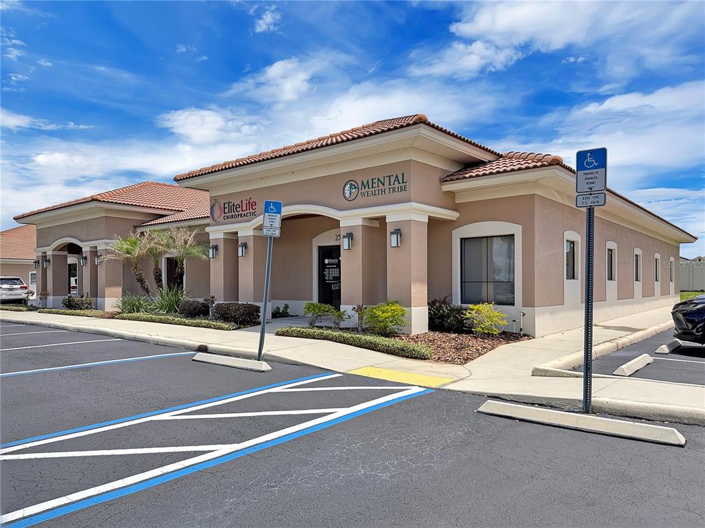 A tan commercial building with a tile roof features signage for a chiropractic office — 2320 NORTH BOULEVARD W UNIT A, DAVENPORT, FL