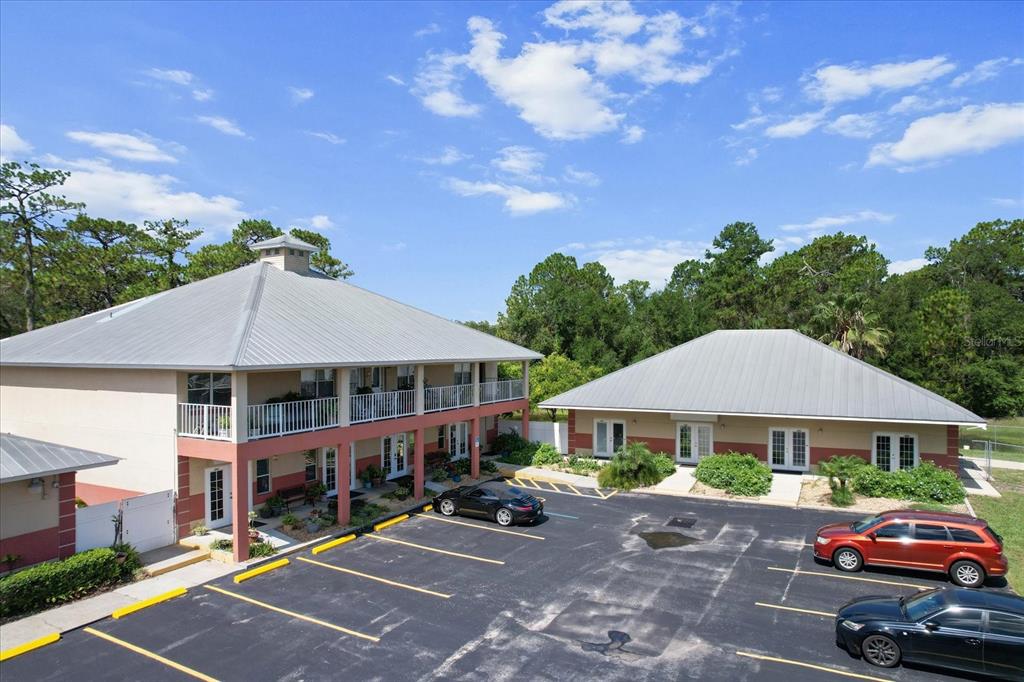 An exterior view of two tan commercial buildings with metal roofs and a parking lot — 3438 N CITRUS AVENUE, CRYSTAL RIVER, FL