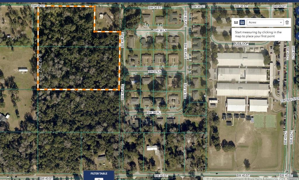 This is a satellite map showing a wooded lot outlined in orange next to residential housing — 4700 SW 36TH STREET, OCALA, FL