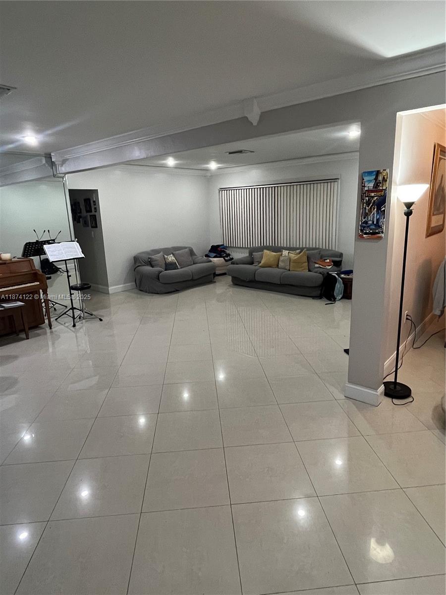 A living room features light tile flooring, two grey sofas, and a piano — 7521 SW 57th Ter, Miami FL 33143, MIAMI, FL