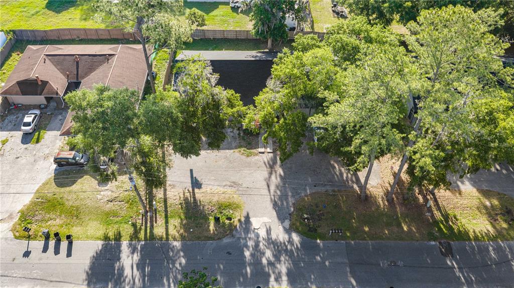 An aerial view shows two houses with dark roofs, large trees, and a shared driveway — 4111 SE 22ND AVENUE, OCALA, FL
