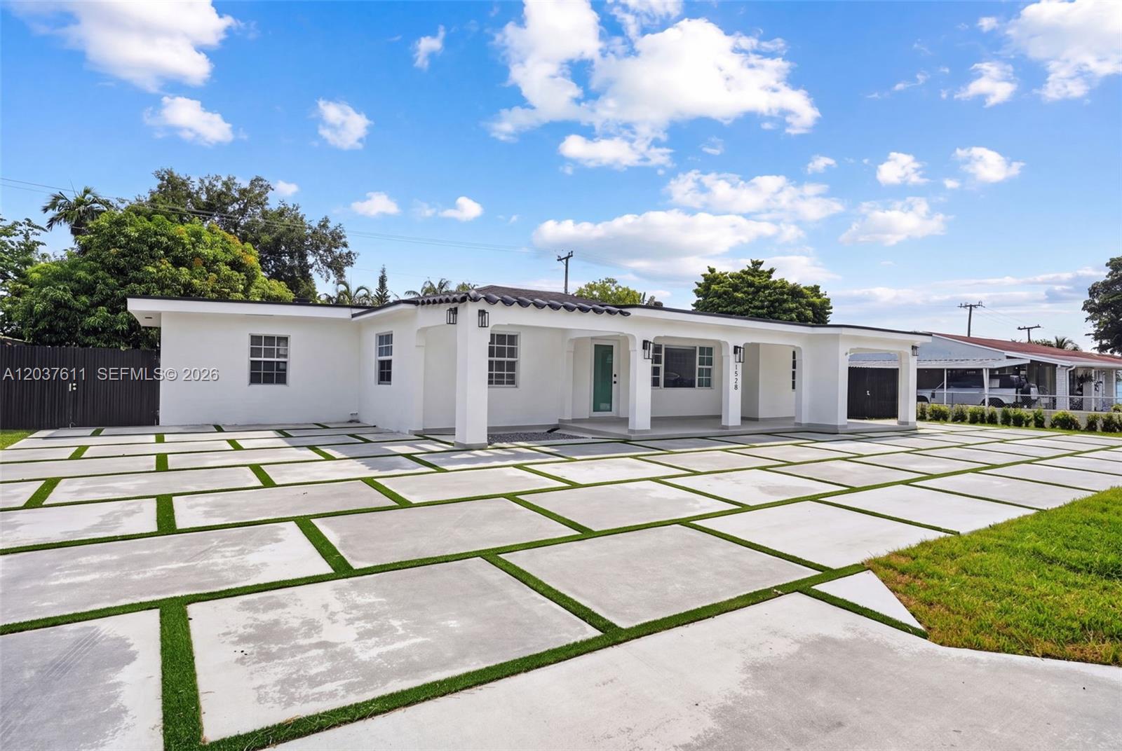A white single-story house features a large concrete paver driveway with artificial grass strips — 1920 SW 67th Ave, Miami FL 33147, MIAMI, FL