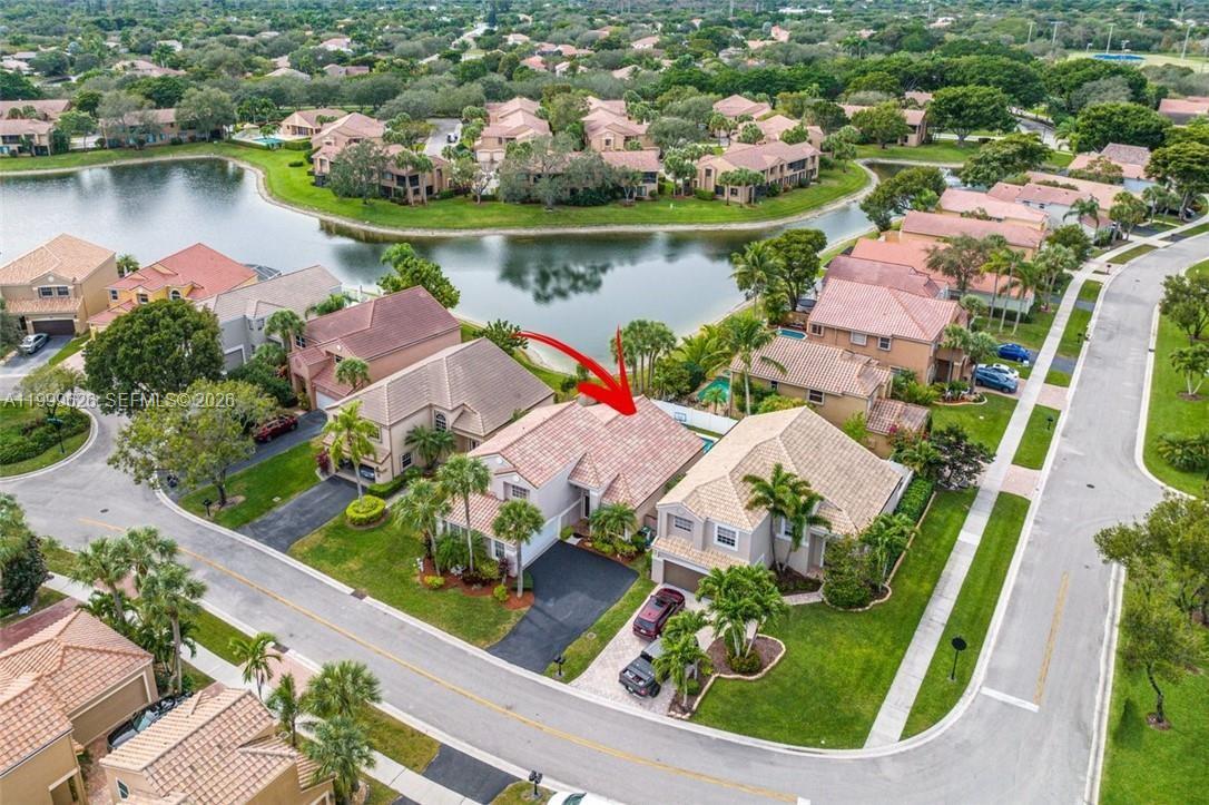 An aerial view shows a suburban house with a red-tiled roof and private pool — 7685 NW 62nd Way, Parkland FL 33067, PARKLAND, FL