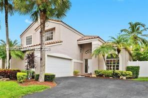 A two-story suburban house with a garage, palm trees, and a paved driveway — 7685 NW 62nd Way, Parkland FL 33067, PARKLAND, FL