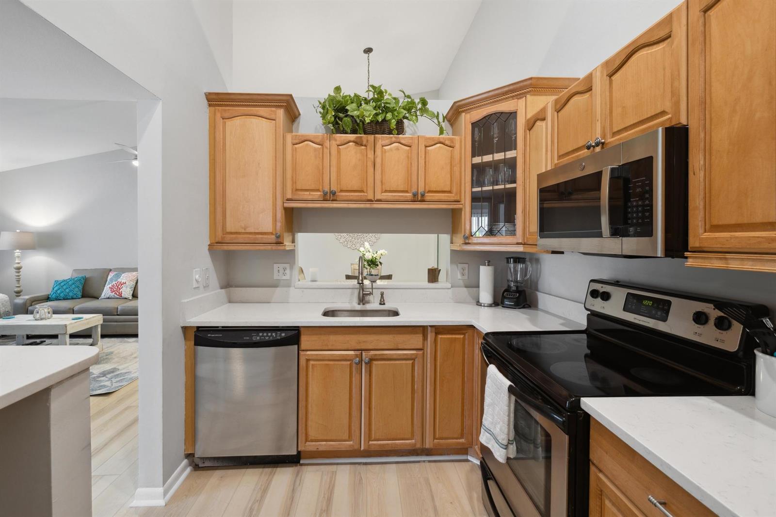 A kitchen features light wood cabinets, stainless steel appliances, and white countertops — 6271 Chasewood Drive # F, Jupiter FL 33458, JUPITER, FL
