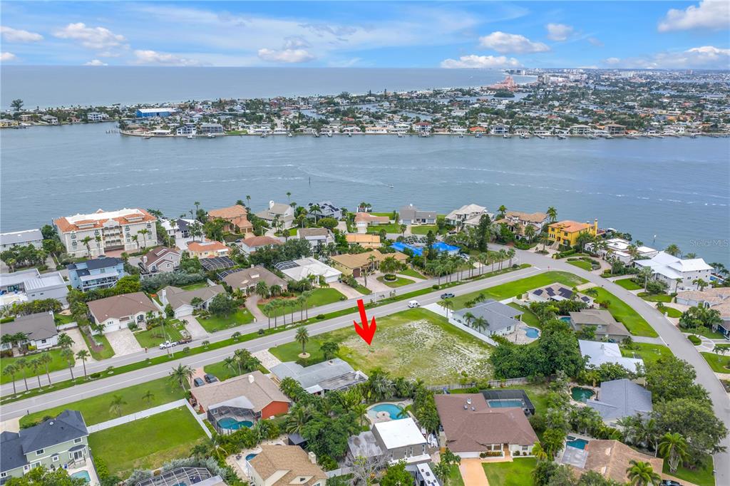 An aerial view shows a vacant residential lot situated in a waterfront neighborhood — 255 MONTE CRISTO BOULEVARD, ST PETERSBURG, FL