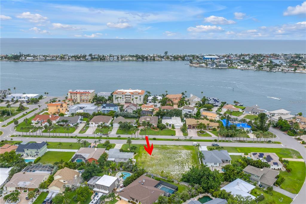 An aerial view shows a vacant residential lot situated near a waterfront neighborhood — 255 MONTE CRISTO BOULEVARD, ST PETERSBURG, FL