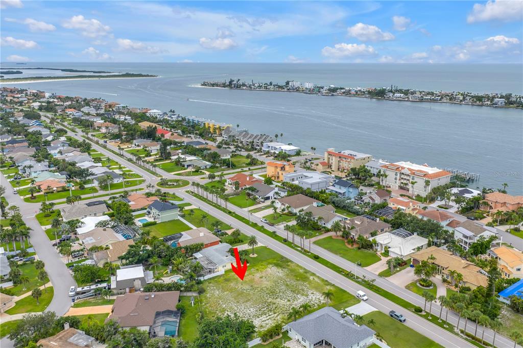 An aerial view shows a vacant residential lot situated in a coastal neighborhood near water — 255 MONTE CRISTO BOULEVARD, ST PETERSBURG, FL