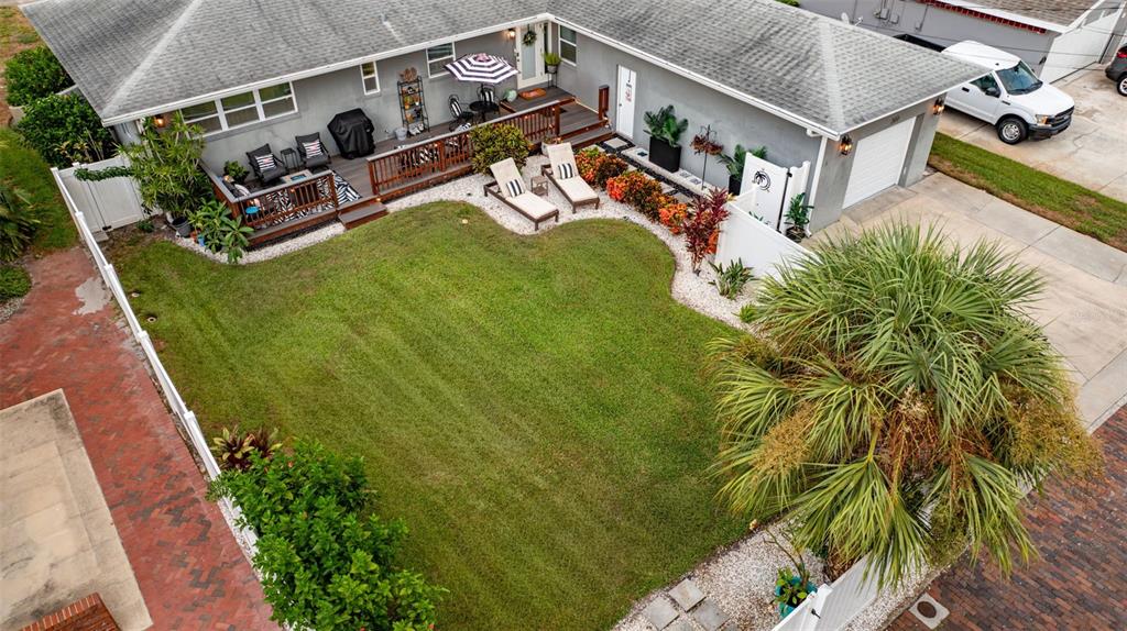 An aerial view shows a house with a wooden deck, lawn, and palm tree — 200 PARK STREET N, ST PETERSBURG, FL