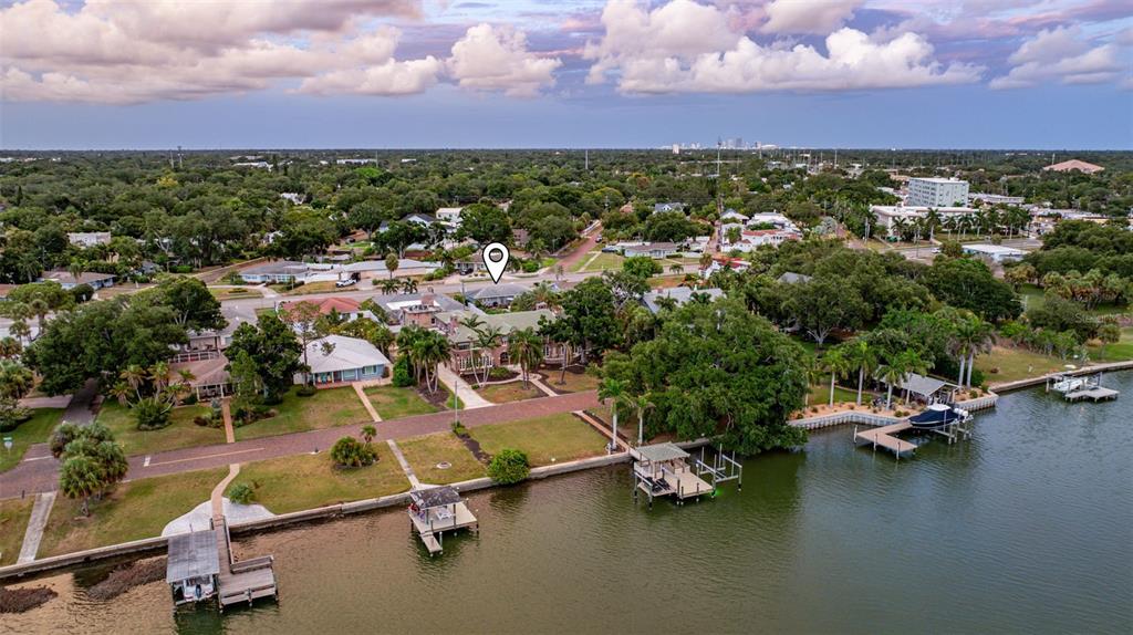 An aerial view shows waterfront houses with private docks along a canal — 200 PARK STREET N, ST PETERSBURG, FL