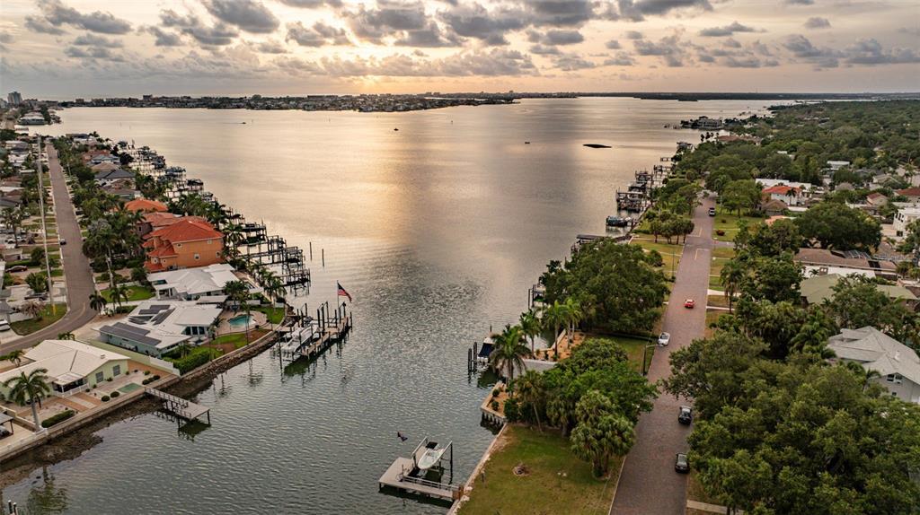 An aerial view shows a canal leading into a bay surrounded by waterfront residential homes — 200 PARK STREET N, ST PETERSBURG, FL