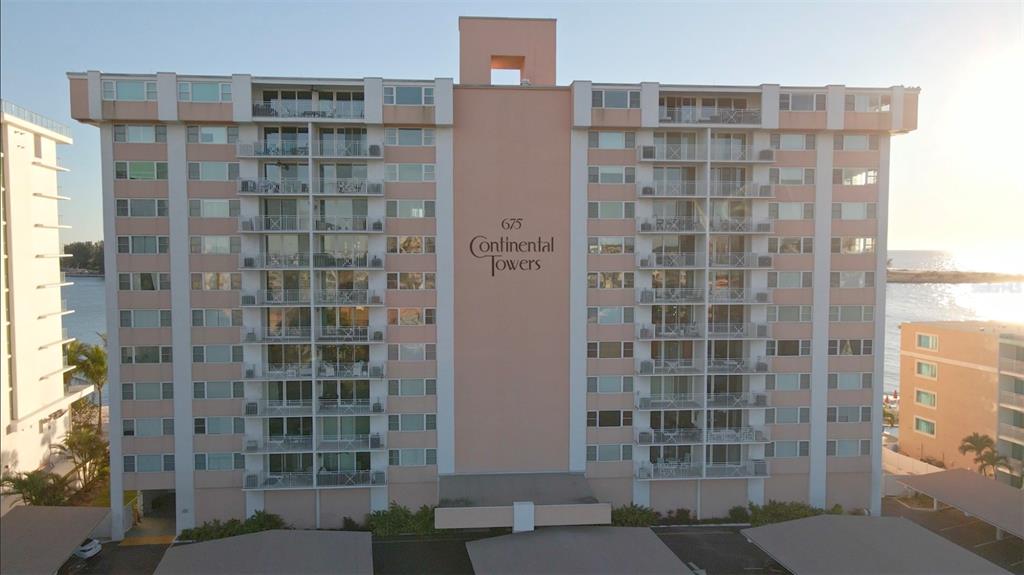 An exterior view of the multi-story Continental Towers apartment building with balconies and parking structures — 675 S GULFVIEW BOULEVARD UNIT 606, CLEARWATER BEACH, FL