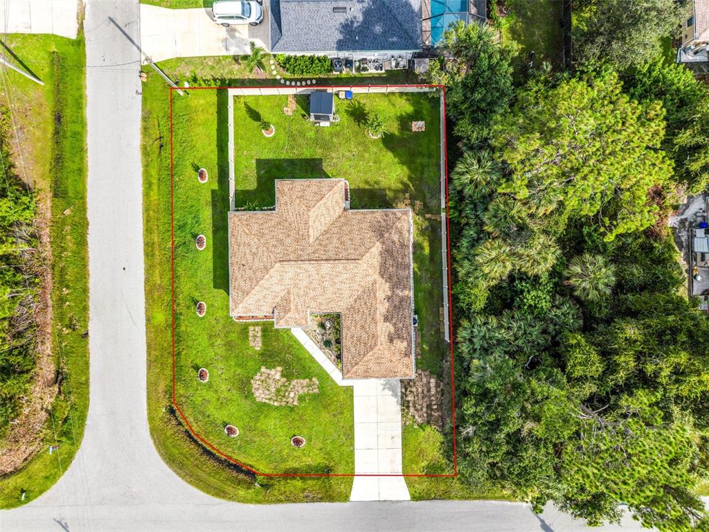 An aerial view shows a single-story house with a brown roof on a landscaped lot — 4323 MICHALER STREET, NORTH PORT, FL