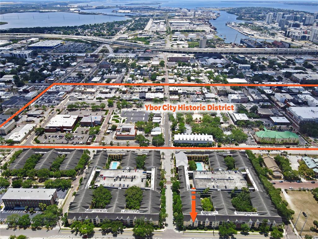 This aerial view shows an apartment complex in the foreground and the Ybor City Historic District — 1810 E PALM AVENUE UNIT 5122, TAMPA, FL