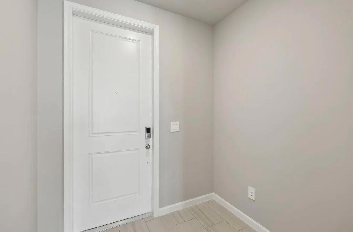 A white door with a smart lock stands in a room with light gray walls — 526 Salisbury Circle, Fort Pierce FL 34982, FORT PIERCE, FL