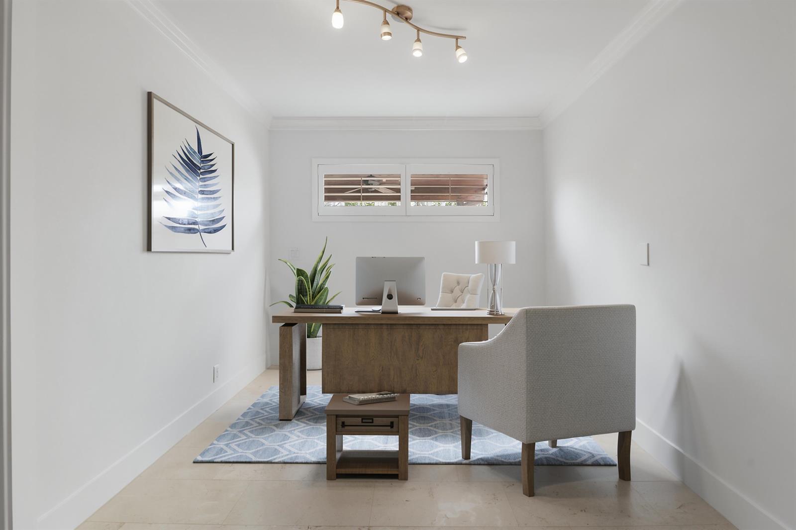 A home office features a wooden desk, a patterned blue rug, and a white chair — 19931 Jasmine Drive, Jupiter FL 33469, JUPITER, FL