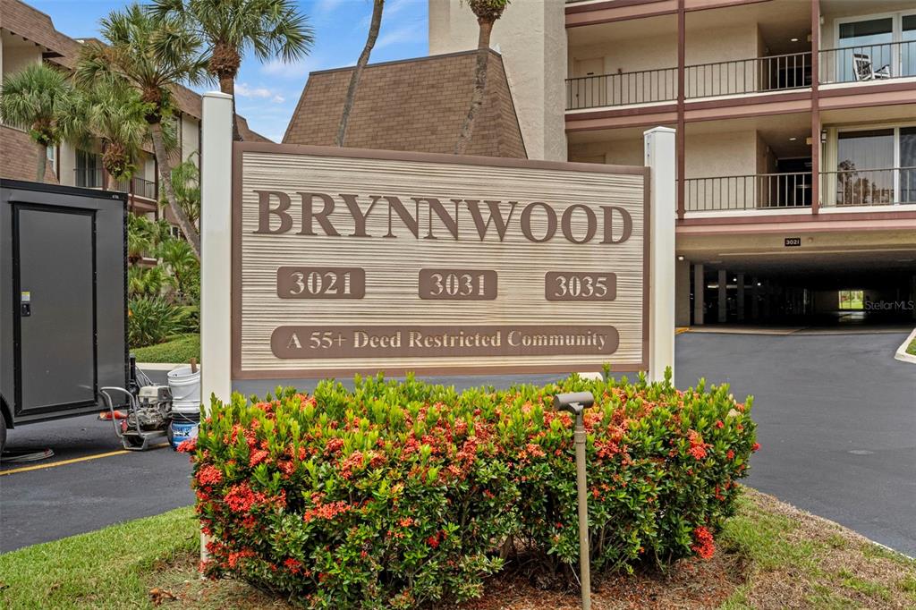 A sign for the Brynnwood 55+ community stands in front of a multi-story apartment building — 3035 COUNTRYSIDE BOULEVARD UNIT 24B, CLEARWATER, FL