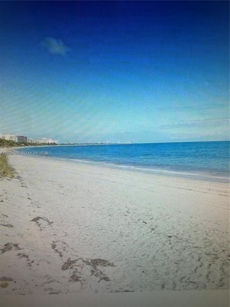 A sandy beach stretches along the ocean under a clear blue sky — 1111 Crandon Blvd # B506, Key Biscayne FL 33149, KEY BISCAYNE, FL